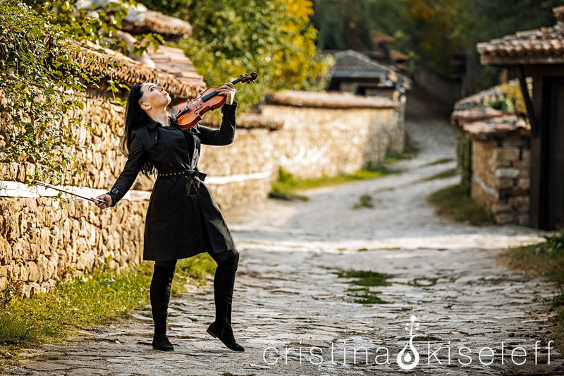 Cristina Kiseleff Electric Violinist performing Schindler's List Violin Cover dressed in an elegant coat