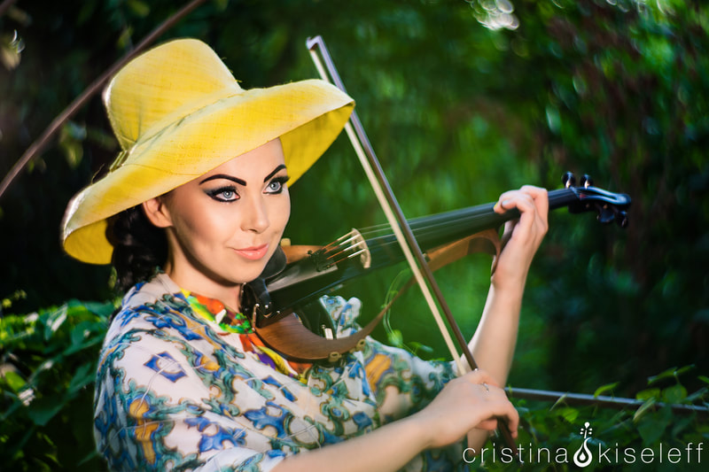 Cristina Kiseleff Electric Violinist plays a Yamaha YEV-104 violin wearing a Channel dress and hat in a Japanese garden